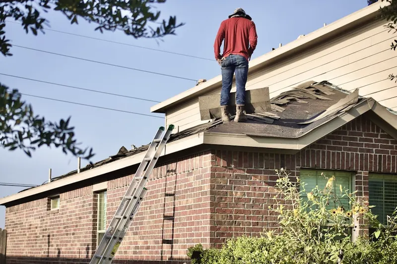 Professional roofer working on a residential roof in East Bear Valley